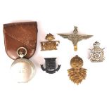 A US pocket compass and a group of military badges.