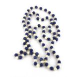 A long necklace of cultured pearls and lapis lazuli beads, bead size 8.5mm necklace L. 118cm.