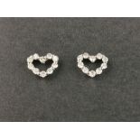 A pair of 18ct white gold (stamped 18k) heart shaped earrings set with brilliant cut diamonds, L.