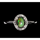 A 925 silver opal and white stone set cluster ring, (O).