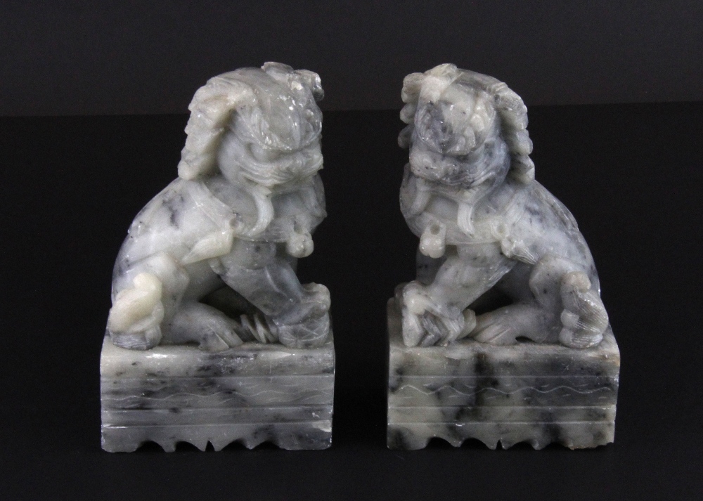 A pair of Chinese carved soapstone lion dog figures, H. 12cm.