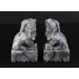 A pair of Chinese carved soapstone lion dog figures, H. 12cm.