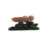 A Chinese carved ruby zoisite figure of a carp on a base, l. 7.5cm H. 3.5cm.