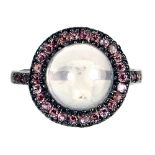 A 925 silver ring set with cabochon cut rose quartz surrounded by pink sapphires, (S).