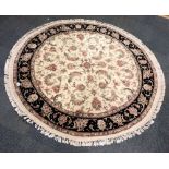 A Turkish handmade circular wool on cotton rug, Dia. 1.52m