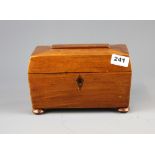 A polished mahogany sarcophagus shaped tea caddy, L. 23cm.