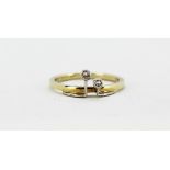 A 14ct yellow gold (stamped 585) ring set with two brilliant cut diamonds, (O).