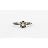 A 9ct white gold diamond set halo ring with diamond set shoulders, (Q.5).