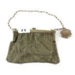 A white metal chain mail purse with a silver compact and a smaller white metal chain mail purse