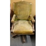 A leather upholstered mahogany revolving desk chair.