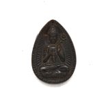 A Chinese carved horn amulet of a Buddhist deity, H. 7cm.