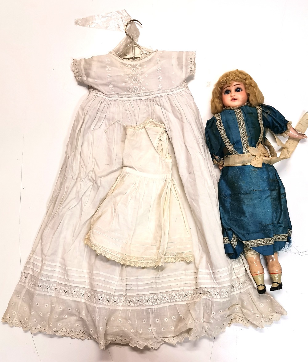 A Victorian wax head and composition doll with original silk dress, together with a Christening robe