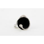 A 14ct white gold (stamped 585) ring set with polished onyx and diamonds, (N.5).