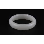 A Chinese white jade polished bangle, internal Dia. 6cm.