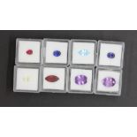 Eight individually boxed unmounted gemstones, including garnet, ruby, amethyst, sapphire, citrine,