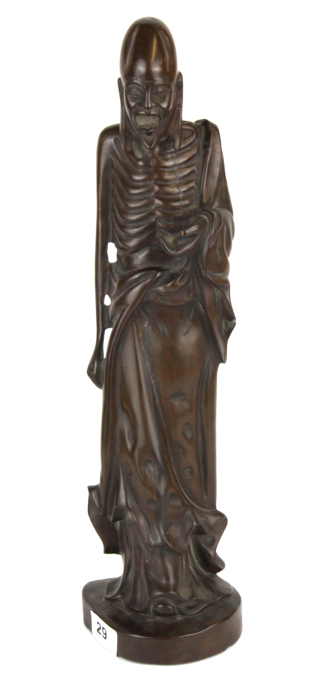 An unusual Chinese carved hardwood figure of an Arhat, H. 45cm. Condition - Some filled age cracking