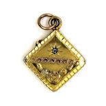 An early gilt metal locket pendant set with an old cut diamond, L. 3.5cm.