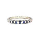 A 925 silver ring set with step cut sapphires, (R.5).