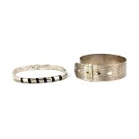 A hallmarked silver buckle bangle, together with a 925 silver bangle.