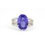 An 18ct white gold ring set with a 6.5ct oval cut richly coloured tanzanite and 0.35ct diamond