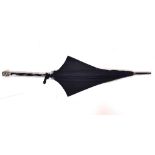 A Victorian umbrella with white metal multi-headed handle.
