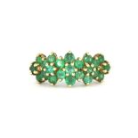 A 9ct yellow gold emerald set cluster ring, (N).