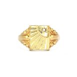 A gentleman's 9ct yellow gold carved signet ring set with a diamond, (U).
