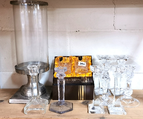A pair of Edinburgh crystal whiskey tumblers with a quantity of glass candle sticks and a storm