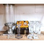 A pair of Edinburgh crystal whiskey tumblers with a quantity of glass candle sticks and a storm