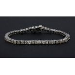 An 18ct white gold diamond set line bracelet, approx. 5.16ct, L. 17cms.