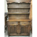 An oak linen fold Welsh dresser, W. 115cm. H. 179cm.