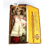 A small 19th Century doll with wax head, arms and legs, H. 24cm.