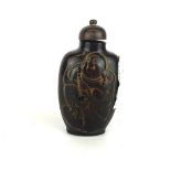 A Chinese carved horn snuff bottle, H. 8cm.