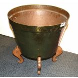 A hammered brass log bucket on a carved wooden stand, Dia. 20cm H. 40cm.