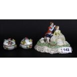 A German porcelain lace figure H. 11cm and two porcelain boxes.