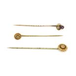 A 9ct yellow gold stone set stick pin, together with a yellow metal amethyst and seed pearl stick