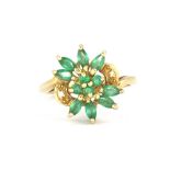 A 9ct yellow gold emerald and diamond set cluster ring, (N).