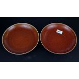 A pair of Chinese red/orange glazed porcelain dishes Dia. 22.5cm six character mark to base.
