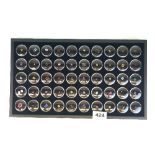 A tray of fifty individually boxed gemstones including sapphires, diamonds, rubies etc.