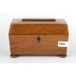 A polished mahogany sarcophagus shaped tea caddy, L. 23cm.