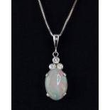 A white metal (tested 18ct gold) diamond and opal set pendant, on an 18ct white gold chain,