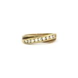 A yellow metal stone set eternity ring, (M).