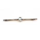 A 9ct rose gold (stamped 9ct) brooch set with an oval cut aquamarine, L. 5.7cm