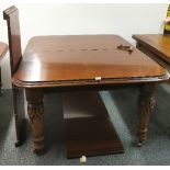 A large Victorian mahogany wind out dining table with carved legs. W. 220cm. L. 245cm. Opening to