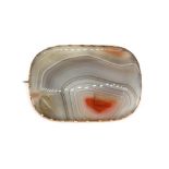 A large rose metal mounted agate brooch, tested min. 9ct gold. 5.5 x 3.8cm.