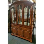 A mahogany mirrored display cabinet with cane design drawer fronts, W. 142cm, H. 205cm.