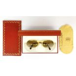 A pair of Must de Cartier vintage sunglasses with original guarantee and box.