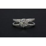 An 18ct white gold diamond set halo ring with diamond set shoulders, together with a IGL