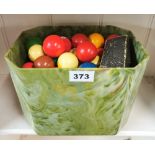 A marbled early plastic bowl full of snooker and pool balls.