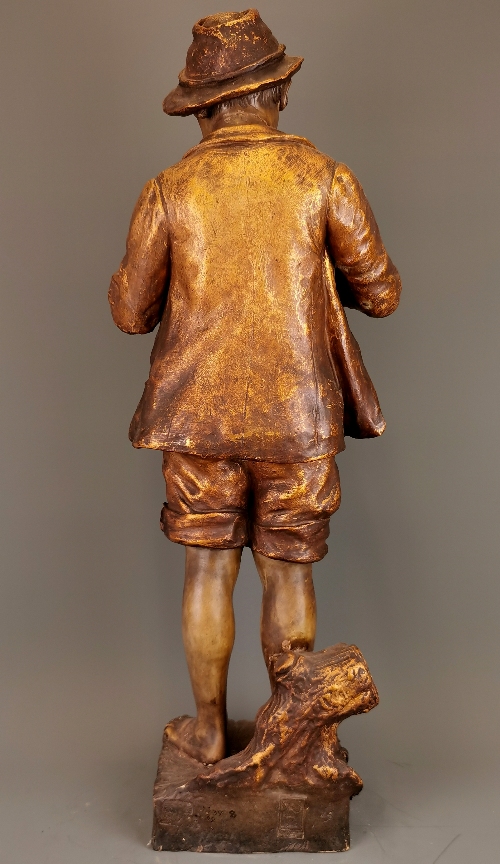 A large 19th Century ceramic figure of a boy fishing. H. 75cm. Repair to neck and feet. - Image 2 of 3